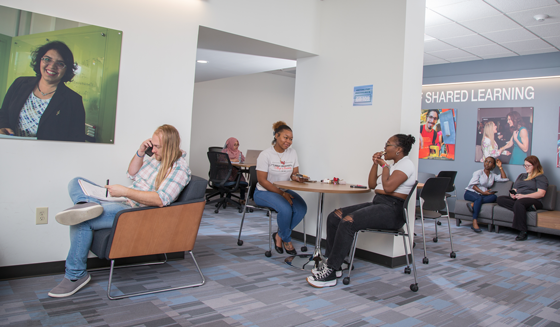 Students sitting in the student lounge area of the Galloway Business Building