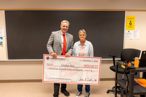 2024 Beck Teaching Excellence Edythe Kirk and President Taylor Holding Check